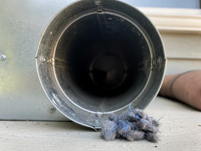 Jupiter Dryer Vent Cleaning technician using specialized equipment to clear severe dryer vent blockage in Jupiter